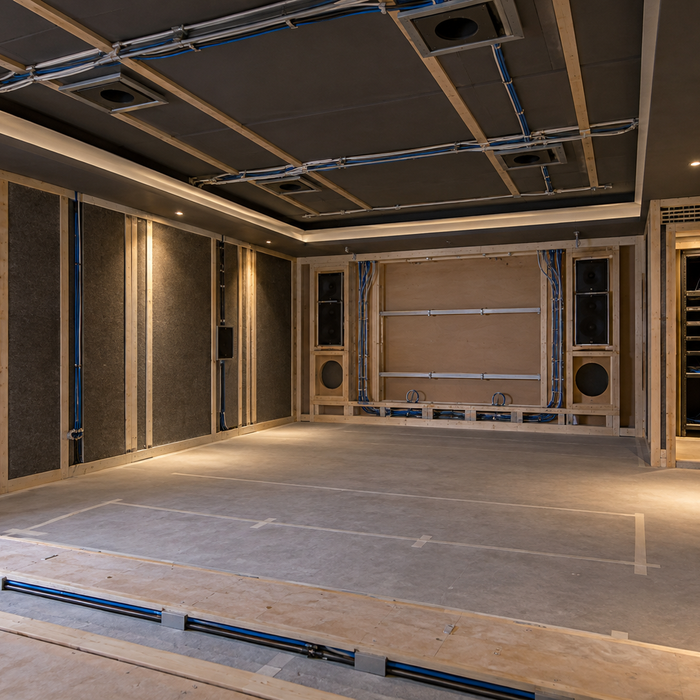 Home cinema room at first fix with planned speaker positions, cabling, screen wall and equipment rack