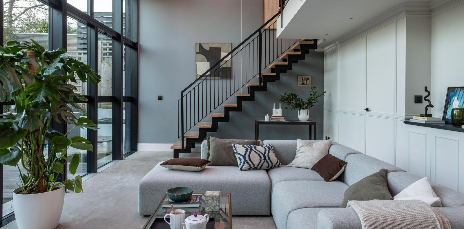 Contemporary living room featuring Lutron lighting control, illustrating an integrated smart home